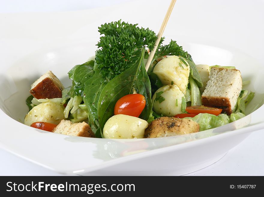 Green Salad in a White bowl, on a white background