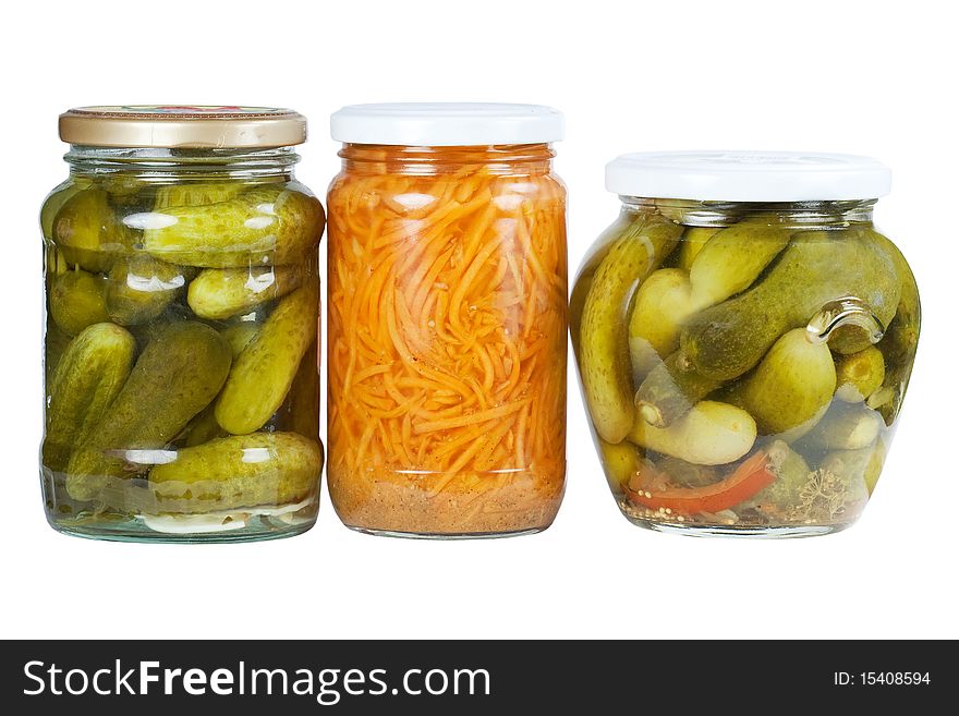 Banks pickled cucumbers and carrots on a white background