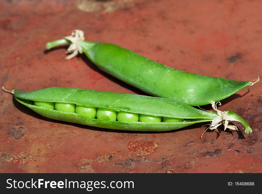 Pod green peas brown background