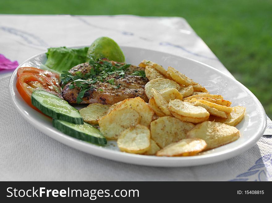 Served meat grill with vegetables in the greek tavern