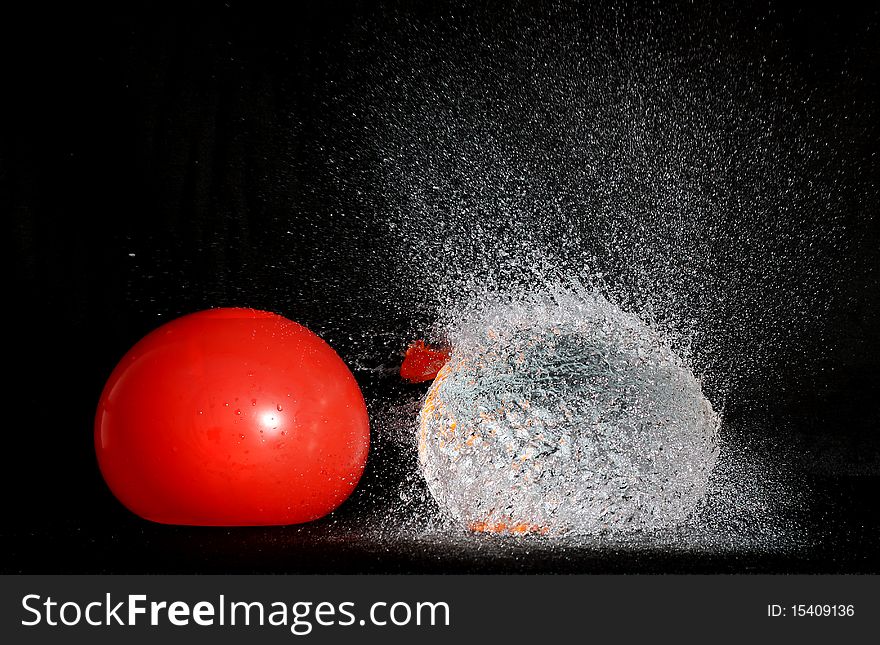 Inflatable balloon full of water broke and sprayed water. Inflatable balloon full of water broke and sprayed water