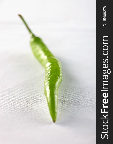 Green chili pepper on white