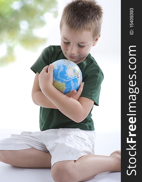 Little boy embracing the globe to protect it. Little boy embracing the globe to protect it