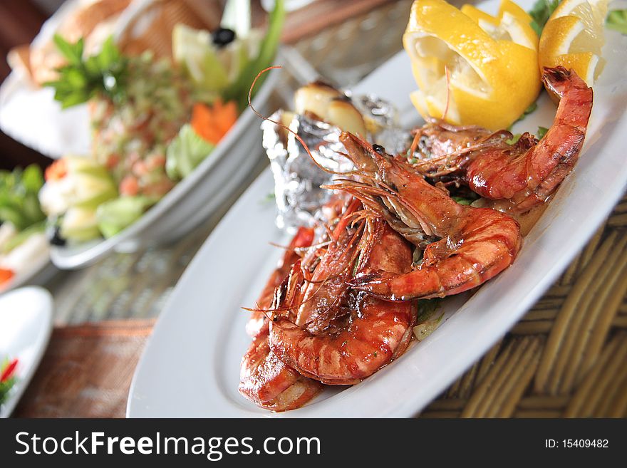 Grilled Shrimps dish with lemon & appetizers. Grilled Shrimps dish with lemon & appetizers