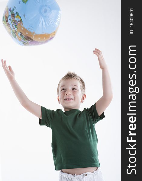 Little boy catching the globe, white background