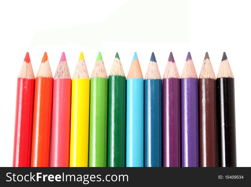 Colorful pencils in a row on white background