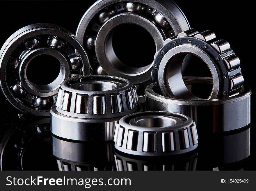 Close-up of a set of ball and roller bearings on a dark background