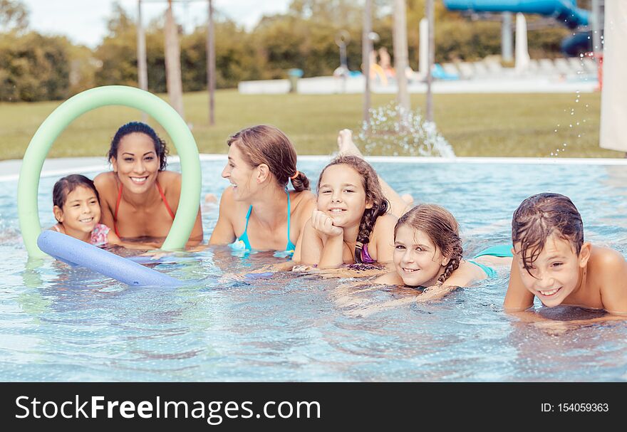 Happy family enjoying in swimming pool