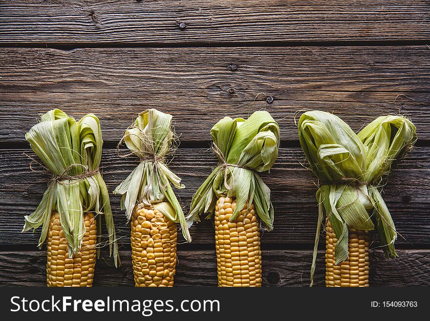 Fresh corn on wooden table a