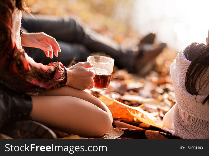 Photo of A cup of hot tea in a transparent mug in female hands