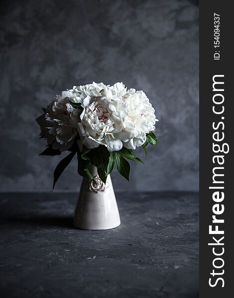 Beautiful peonies on grey concrete background. Wedding, birthday, valentine`s day, gift or women`s day concept