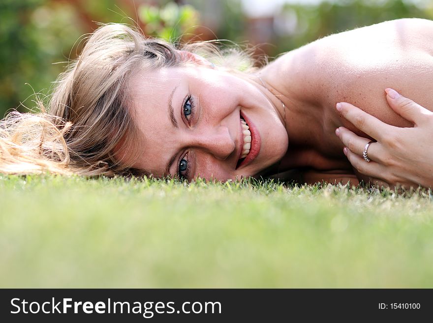 Cute young female lying on grass field at the park. Cute young female lying on grass field at the park