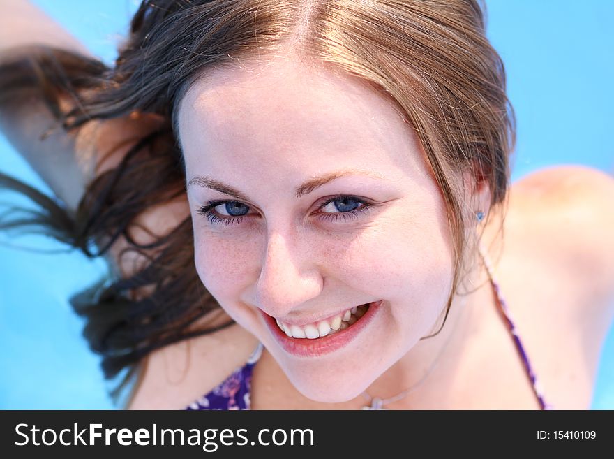 Portrait of a beautiful happy woman in swimming pool