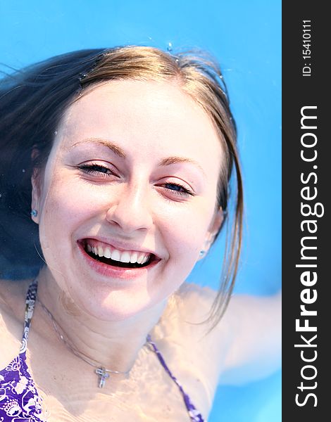 Portrait of a beautiful happy woman in swimming pool