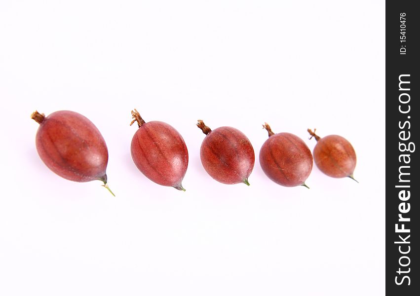 Red gooseberries in a raw on white background