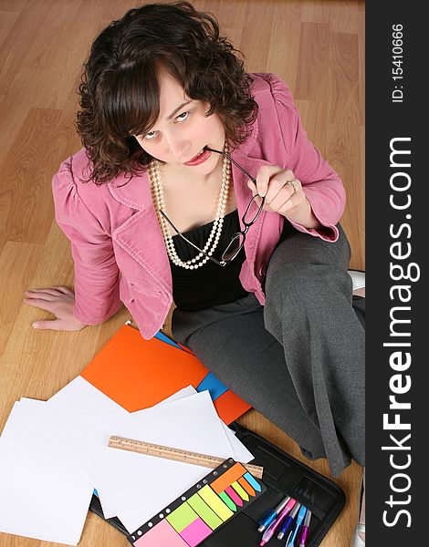 Tired looking business woman sitting on the floor