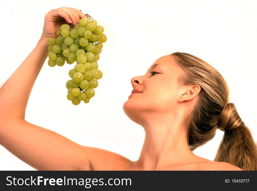 Young woman holding a bunch of grapes. Young woman holding a bunch of grapes
