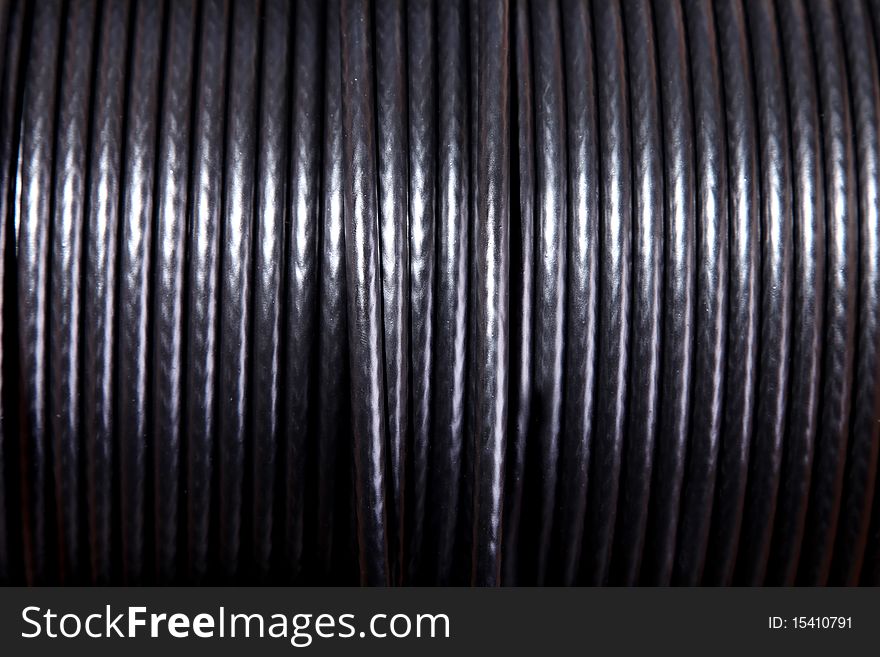 Black power cable on roll. Background image