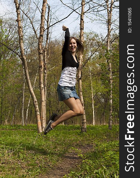 Jumping girl in the woods