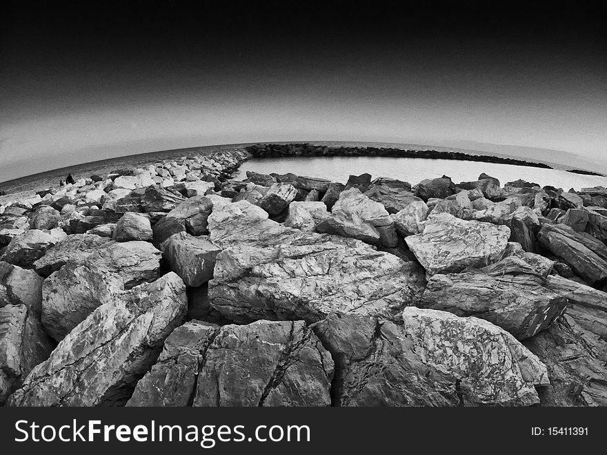 Fisheye View of Rocks over the Sea, Marina di Pisa, Italy. Fisheye View of Rocks over the Sea, Marina di Pisa, Italy