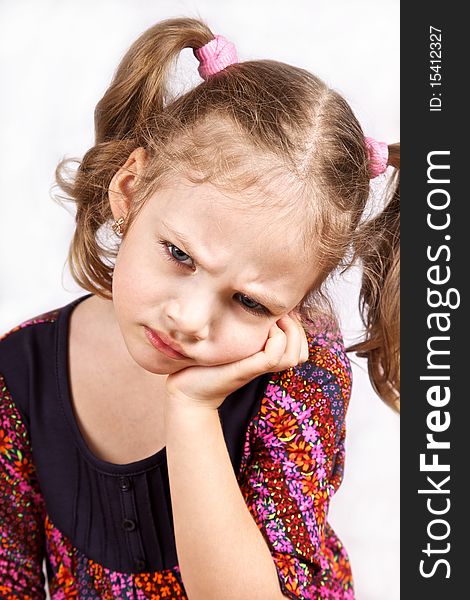 Close-up portrait of a serious cute little girl on white background. Close-up portrait of a serious cute little girl on white background