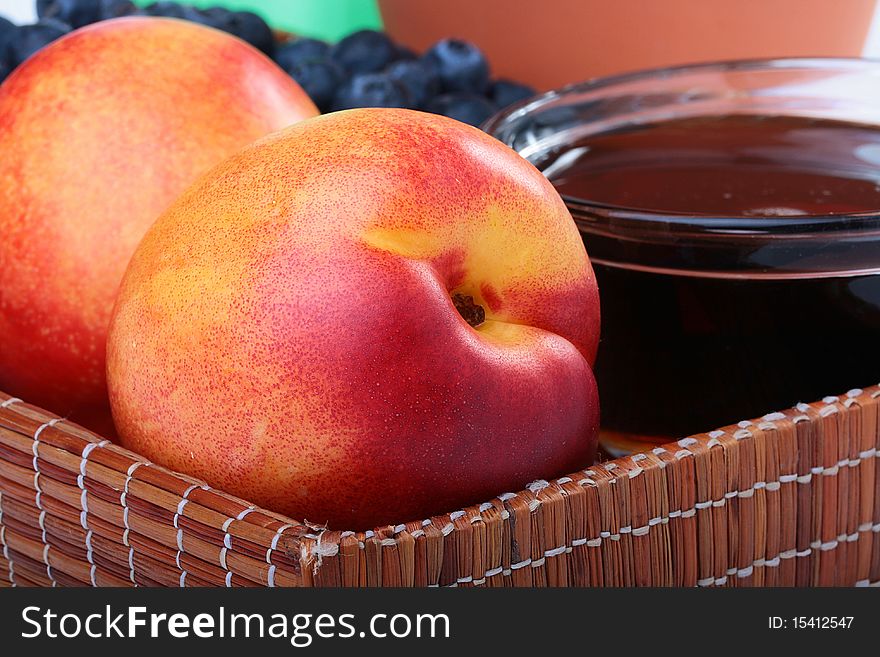 Ripe fruits of a peach with honey in a tray. Ripe fruits of a peach with honey in a tray.