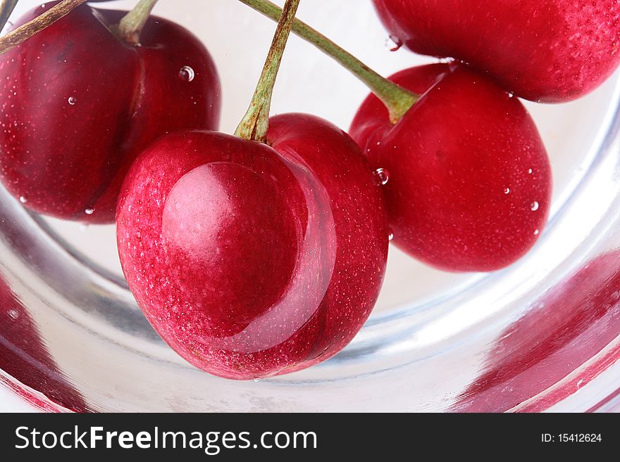 Red berries of a cherry are covered by water. Red berries of a cherry are covered by water.