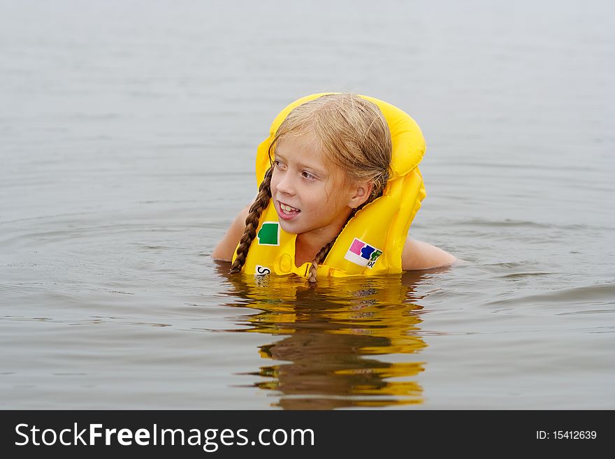 The floating girl in a life jacket