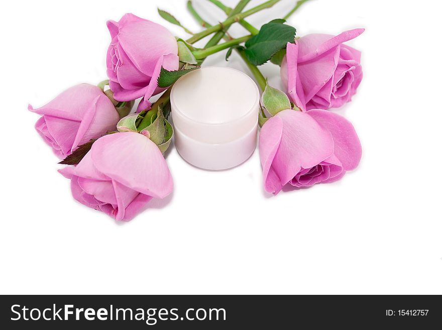 Pink roses and a cosmetic cream isolated on white background. Pink roses and a cosmetic cream isolated on white background