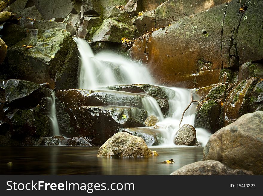 Small waterfall with gray rocks