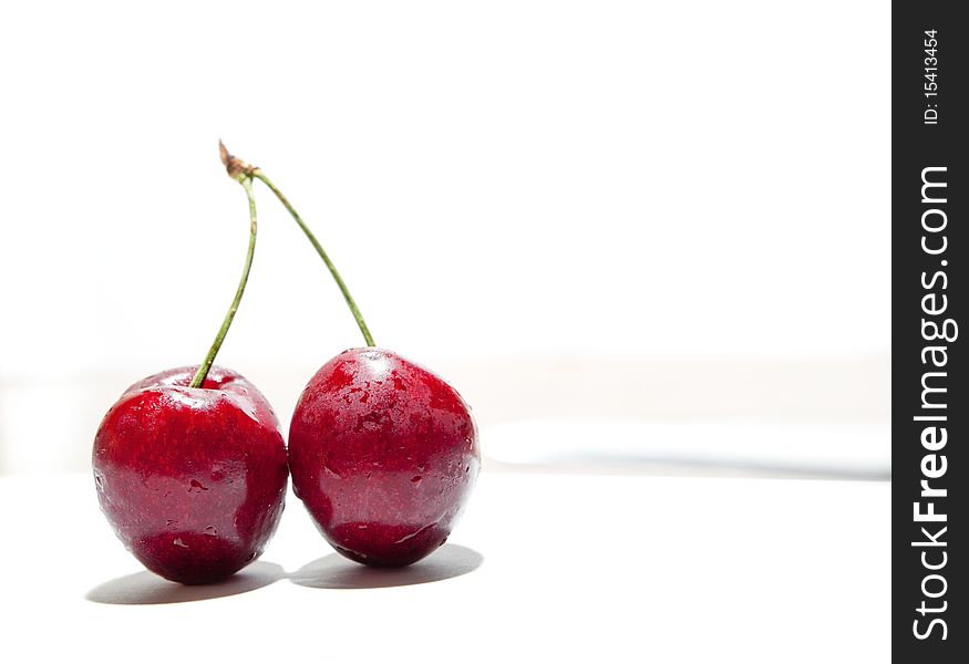 Wet tasty cherries isolated on white