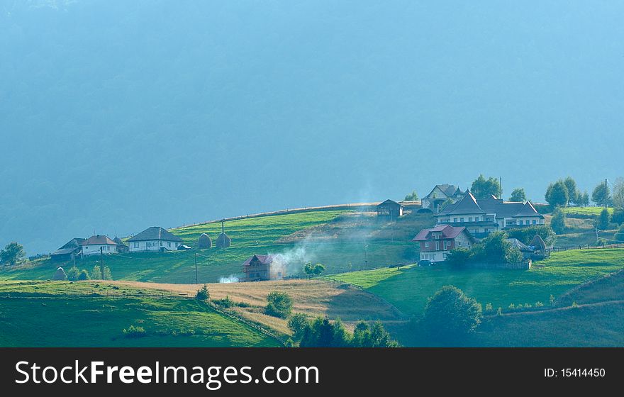 Villages and smoke in romanianas mountains. Villages and smoke in romanianas mountains
