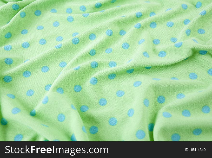 Green fabric with blue polka dots. Green fabric with blue polka dots.