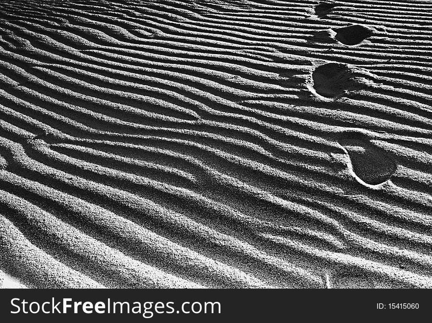 Footprints going over the sand