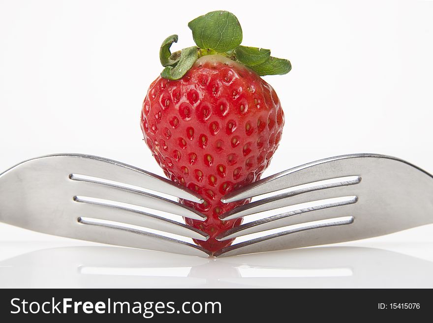 Strawberries with two forks meeting in the middle. Strawberries with two forks meeting in the middle.