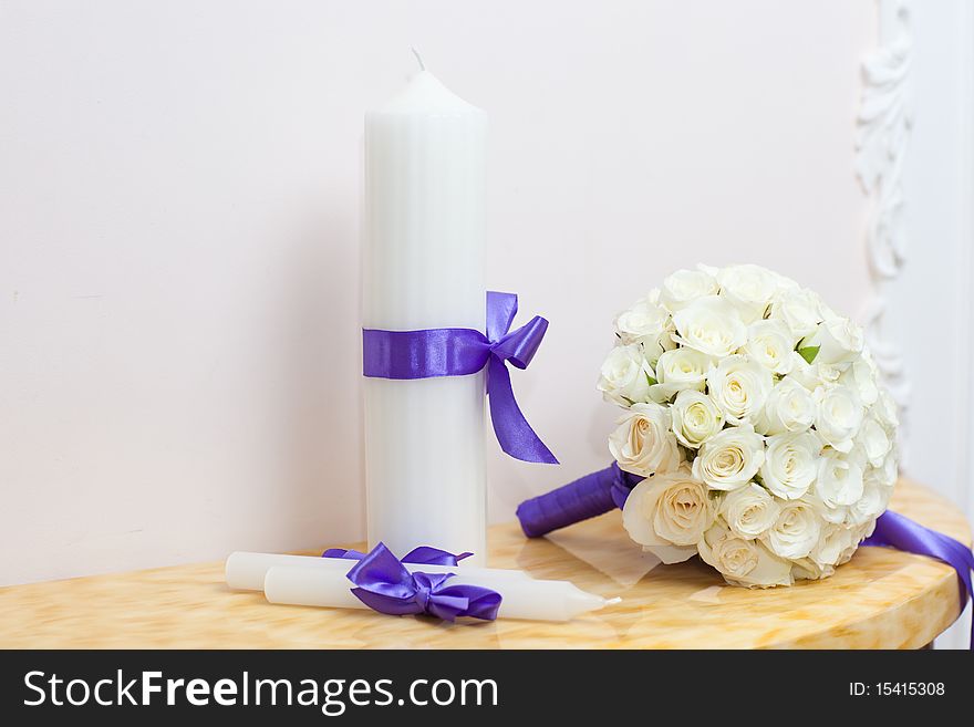 Beautiful wedding bouquet with candles on table