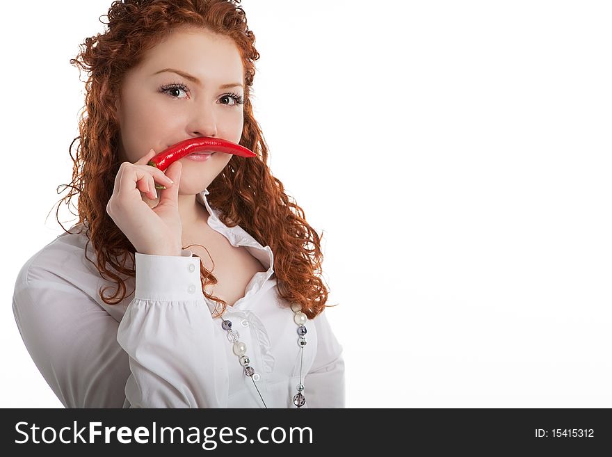 Funny and beautiful young caucasian girl with red hair demonstrating whiskers made of red chilly pepper and standing isolated on white background. Funny and beautiful young caucasian girl with red hair demonstrating whiskers made of red chilly pepper and standing isolated on white background