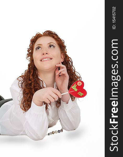 Happy positive nice caucasian girl with sincere beautiful smile lying on floor with bon-bon candy isolated on white. Happy positive nice caucasian girl with sincere beautiful smile lying on floor with bon-bon candy isolated on white