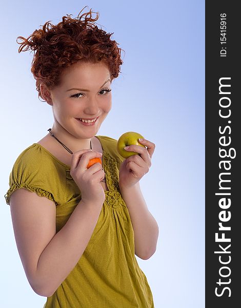 Caucasian girl with positive natural smile making choice between two types of fruits isolated. Caucasian girl with positive natural smile making choice between two types of fruits isolated