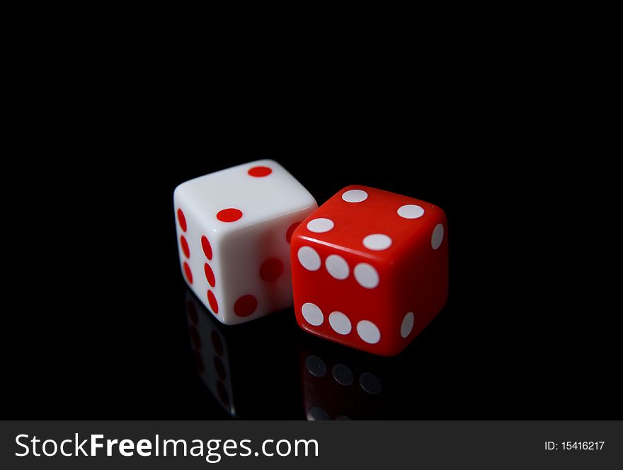 A pair of white and red dice on a black background