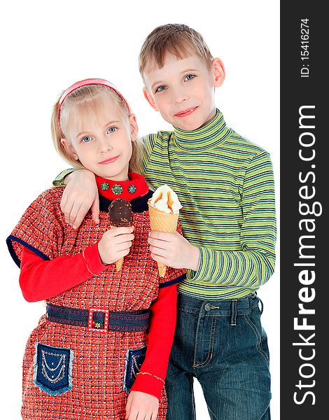 Little boy and girl are eating an ice-cream. Isolated over white background. Little boy and girl are eating an ice-cream. Isolated over white background.