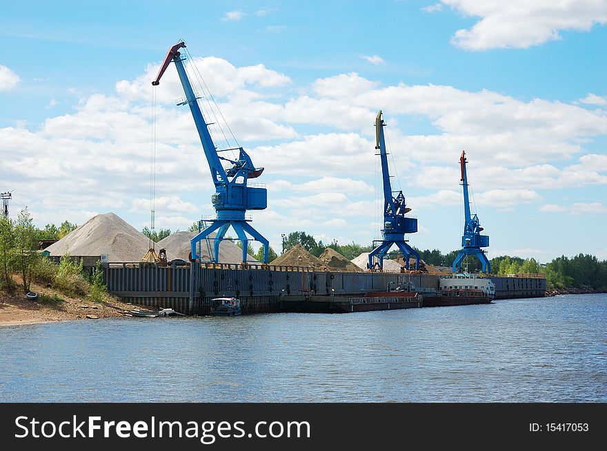 Cranes and sand hills on river port