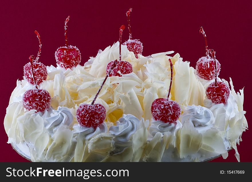 White forest cake with cherry topping