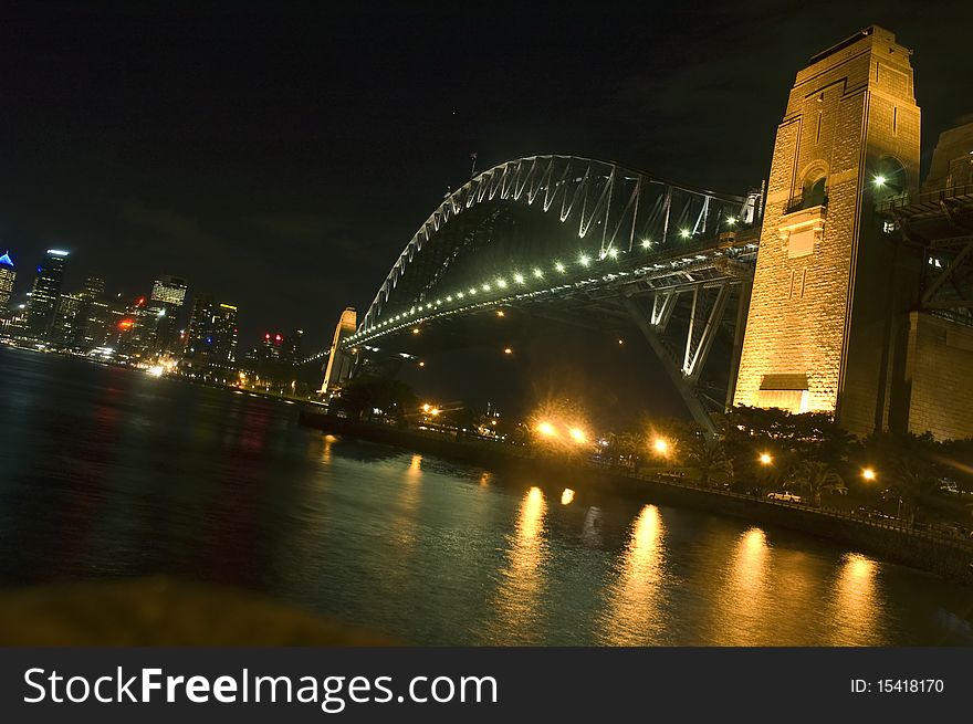 The Harbor Bridge glows at midnight, connecting Sydney's downtown skyline to Milner's point. The Harbor Bridge glows at midnight, connecting Sydney's downtown skyline to Milner's point.