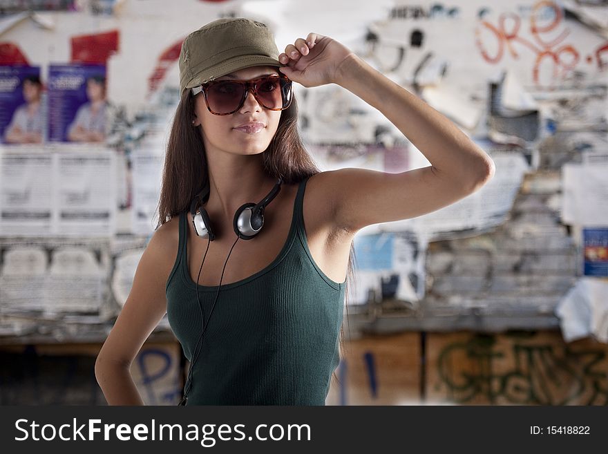 Teenage girl wearing headphones, outdoors