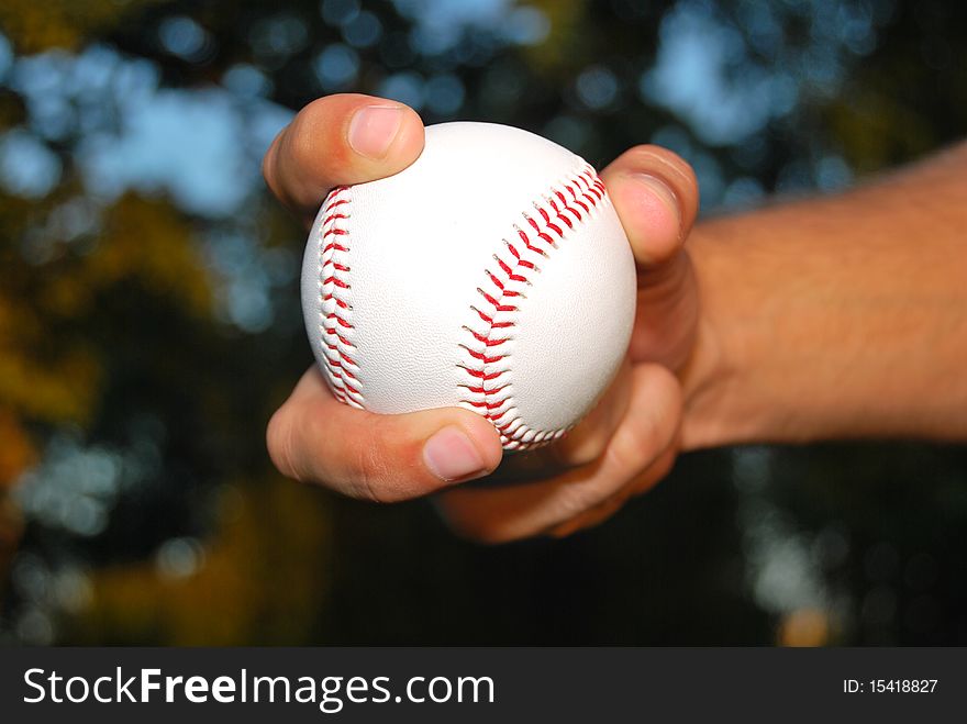 Player Gripping a New Baseball and throws the ball on defense. Player Gripping a New Baseball and throws the ball on defense