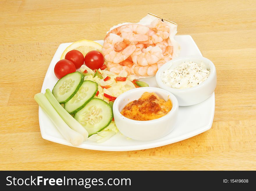 King prawns salad and dips on a wooden table