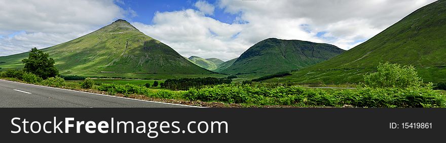 Clouds flying over the green hills of Central Scotland on a sunny summer day