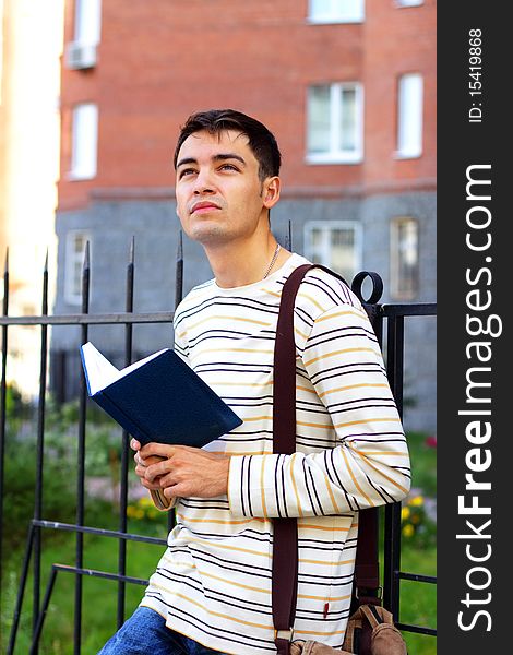Student outdoors on a light background