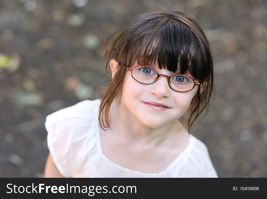 Nice toddler girl in glasses looking into the camera. Nice toddler girl in glasses looking into the camera